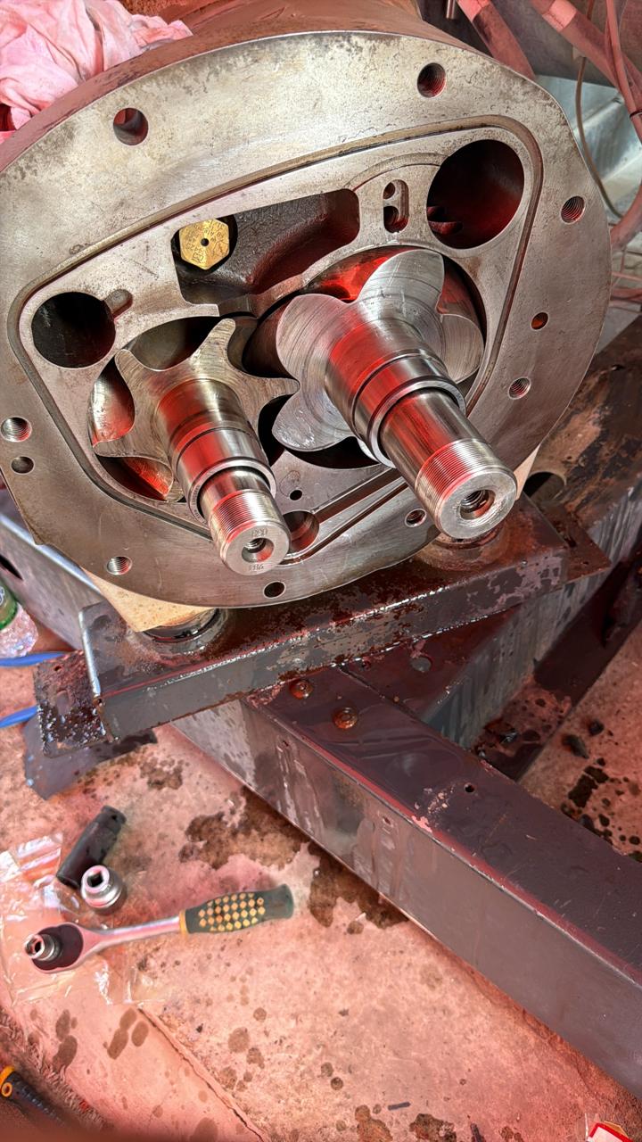 Screw compressor rotors exposed during workshop strip-down and inspection
