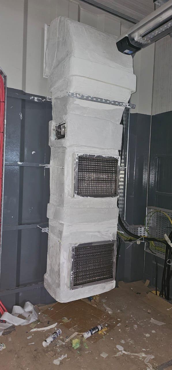 Internal duct riser with return air grilles in a fitted-out technical room
