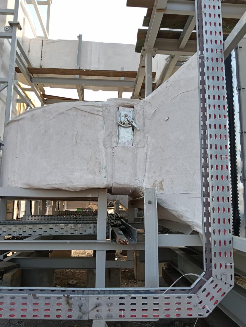 Insulated ductwork supported on galvanised steel frames beside cable tray routes