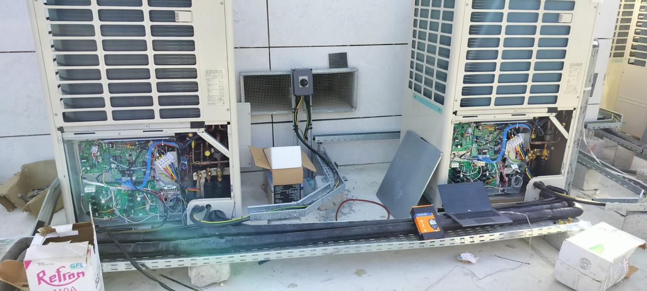 VRF outdoor condensing units opened for electrical and refrigerant commissioning